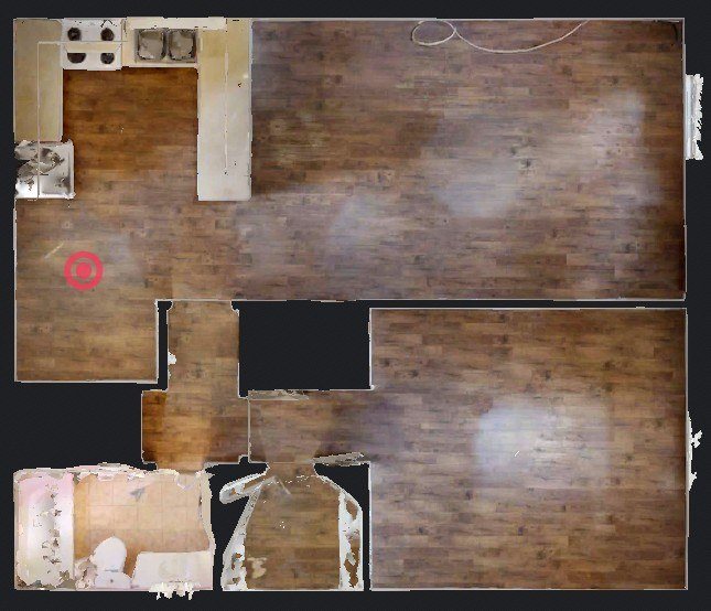 A room with a wooden floor and a white wall with a hole in it.